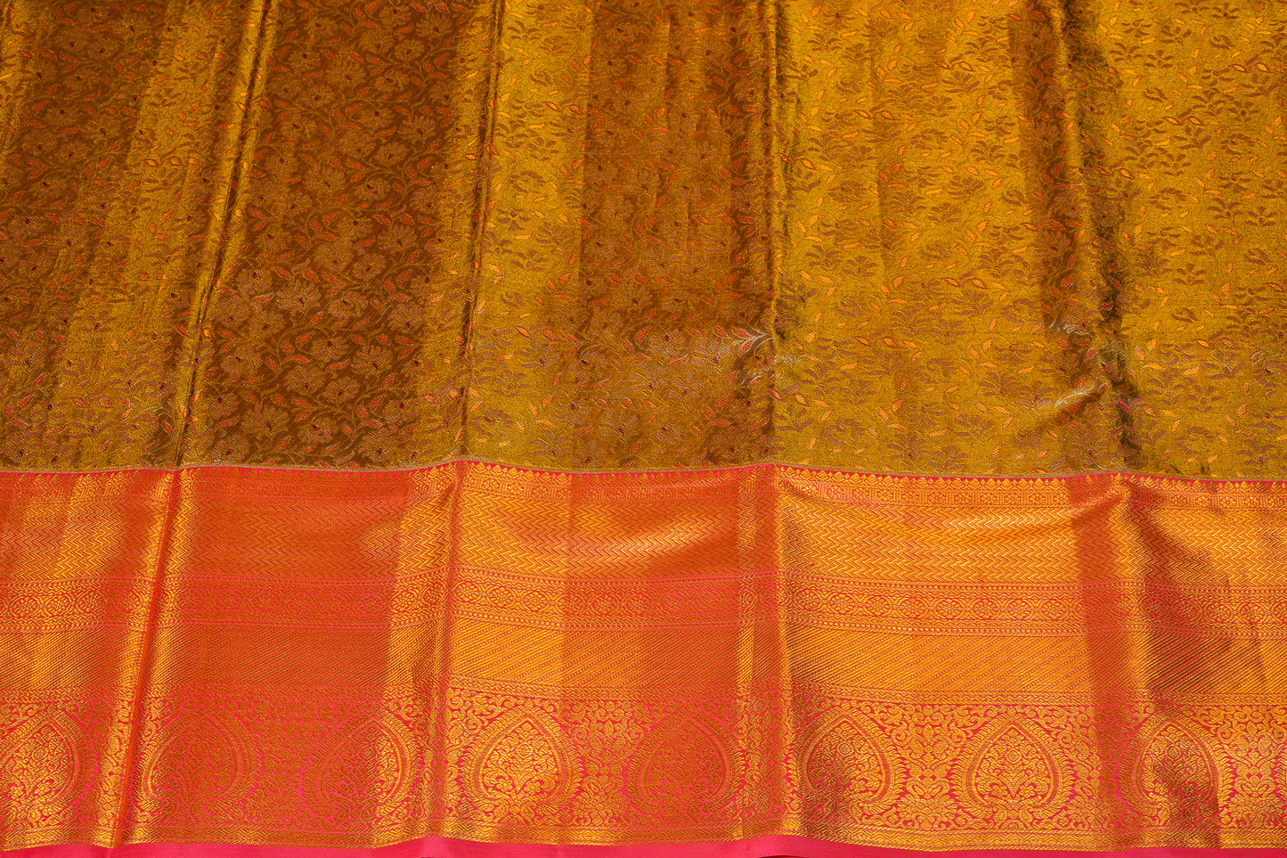 Shimmering golden pattu saree with blushy border