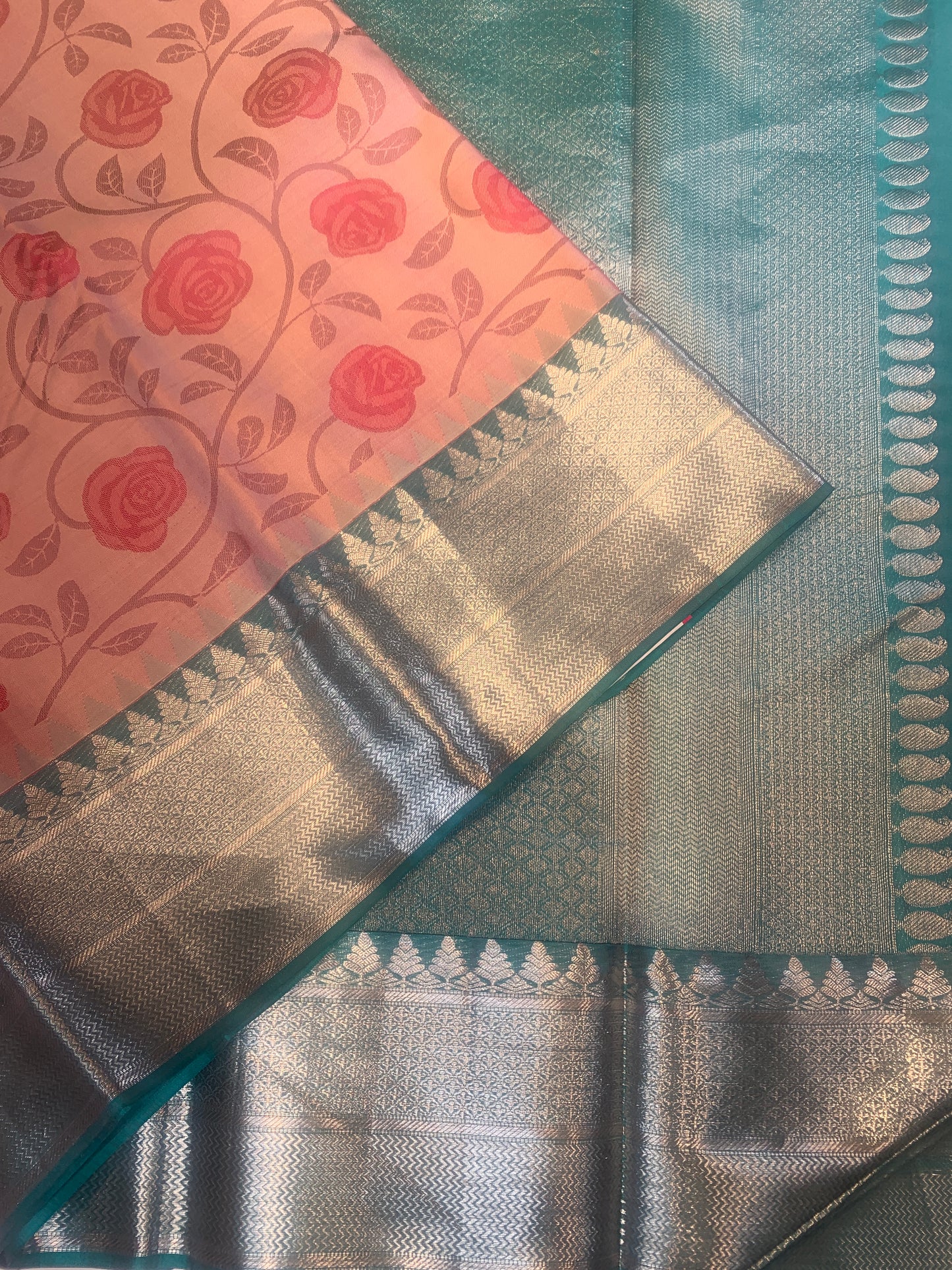 Pink floral pure silk saree with contrast teal border in silver zari