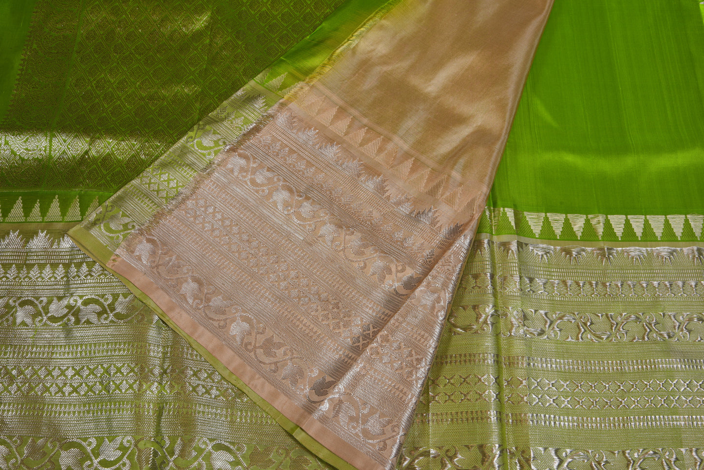 Pistachio coloured pattu saree adorned with shimmering silver zari