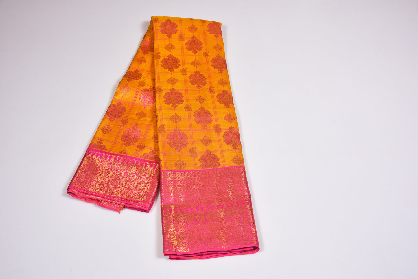 Majestic golden pattu saree with a  blush of long pinky border